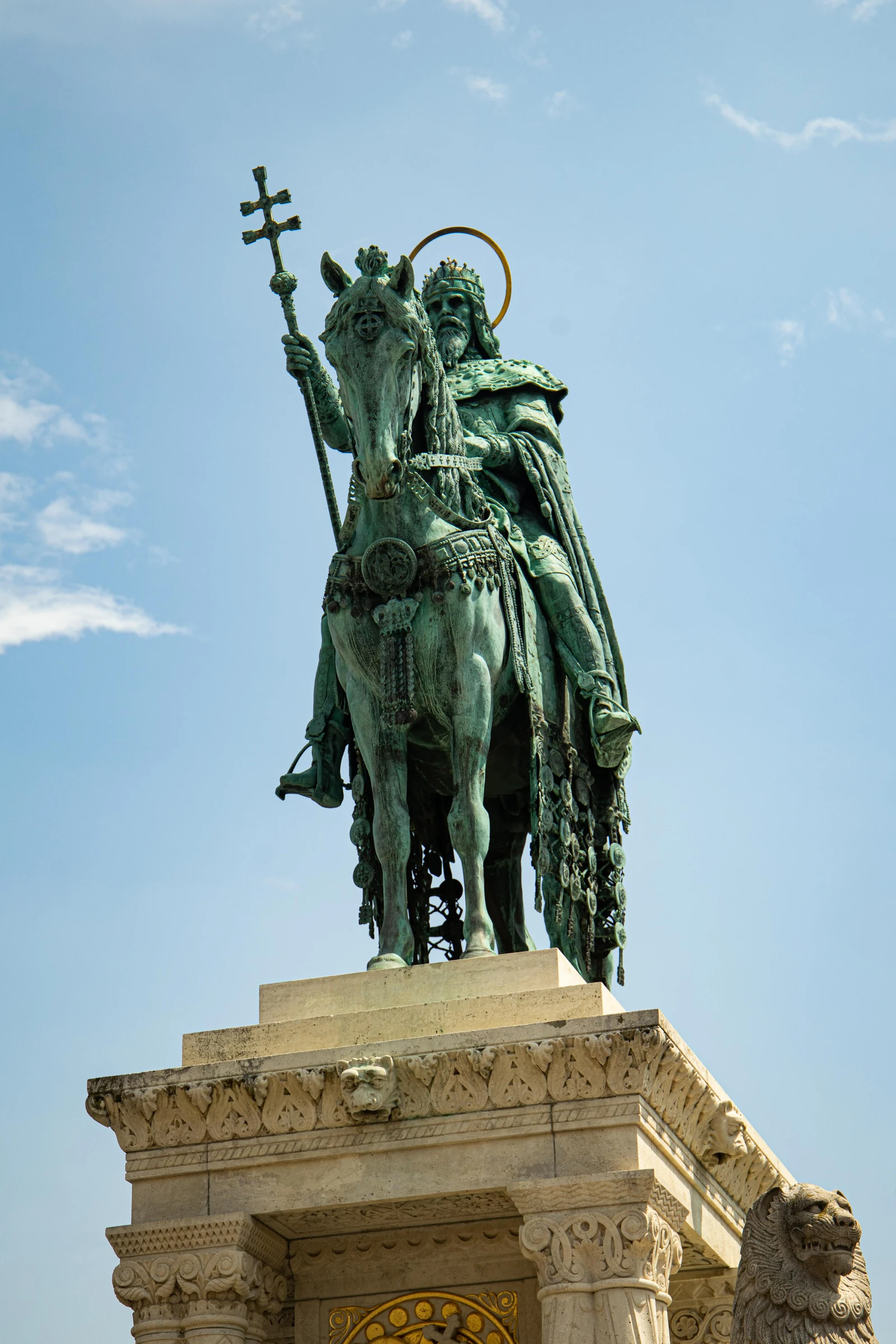 The bronze equestrian monument to Saint Stephen rising against a clear blue sky.