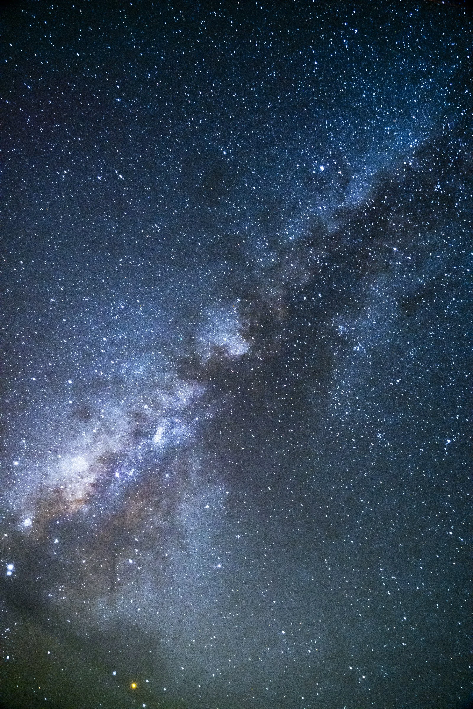 The Milky Way stretching diagonally across a dense field of stars above Iceland.