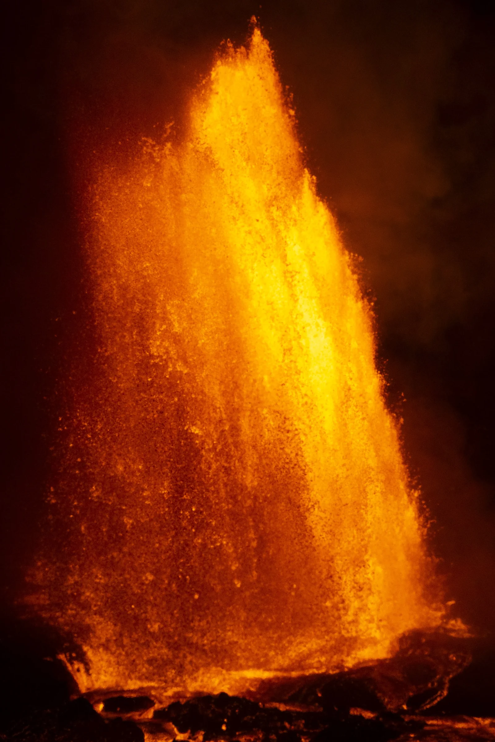 A close vertical view of an orange lava fountain.