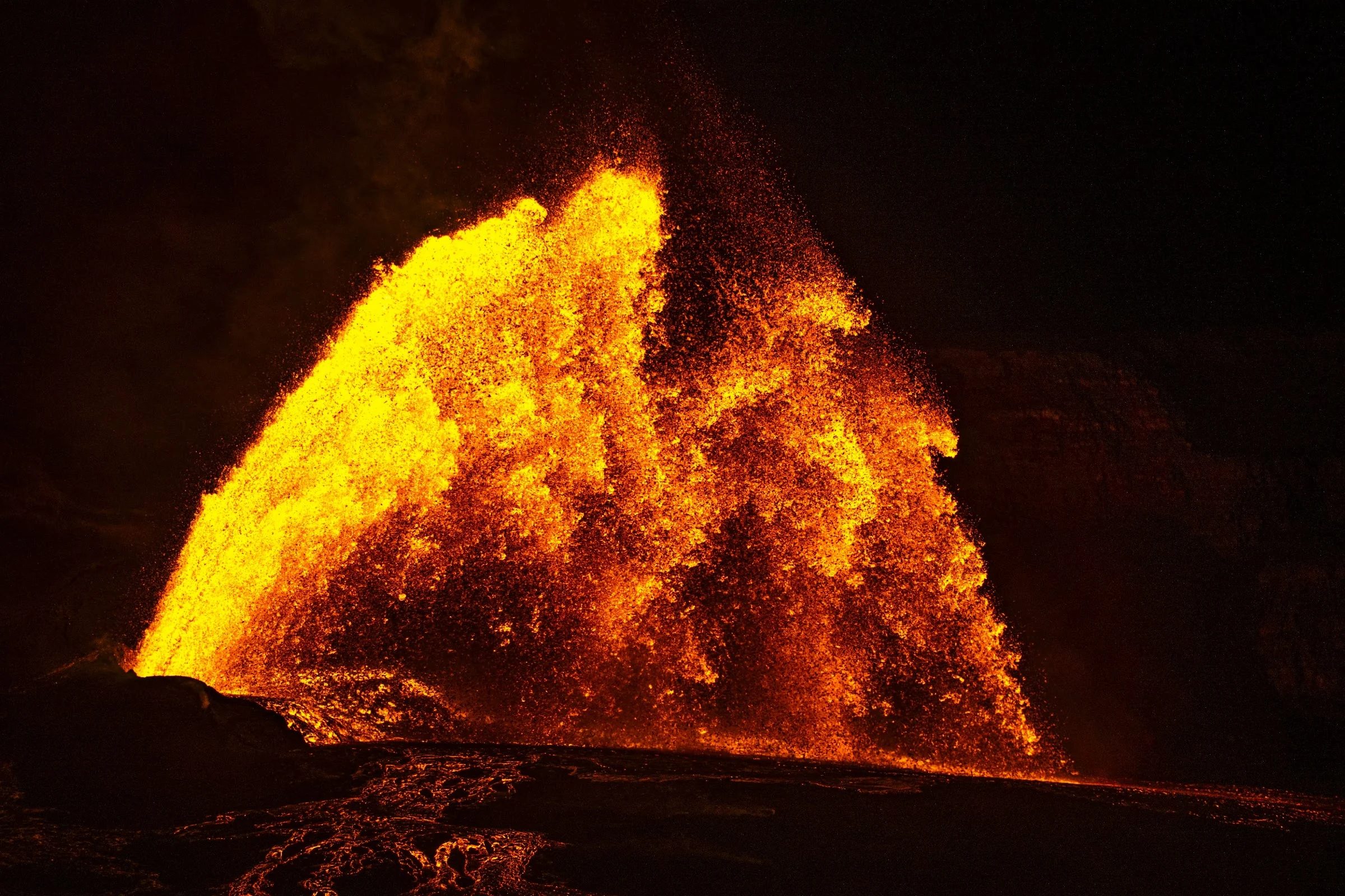 A broad fan of incandescent lava against the night.